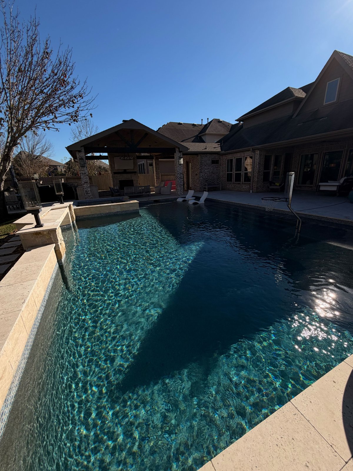Beautiful backyard pool maintained by Admiral Pool Service in Friendswood